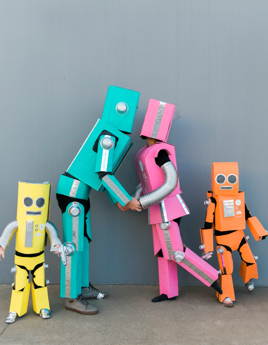 easy halloween costume, four people dressed in colorful diy robot costumes