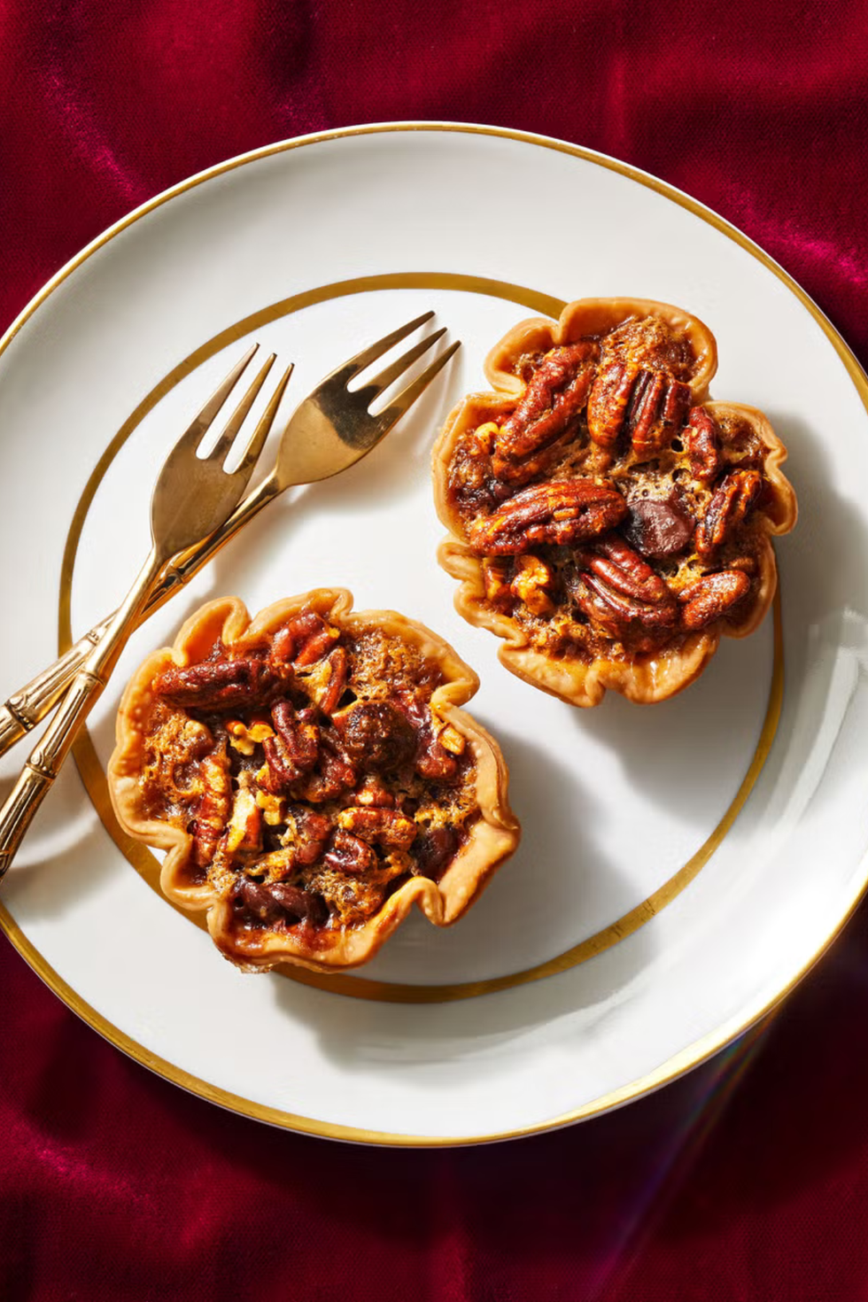 mini chocolate pecan pies on a white plate