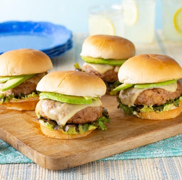 4 turkey burgers on wood board with lemonade