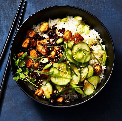 sticky tofu bowl with slices of cucumber, sesame seeds and white rice