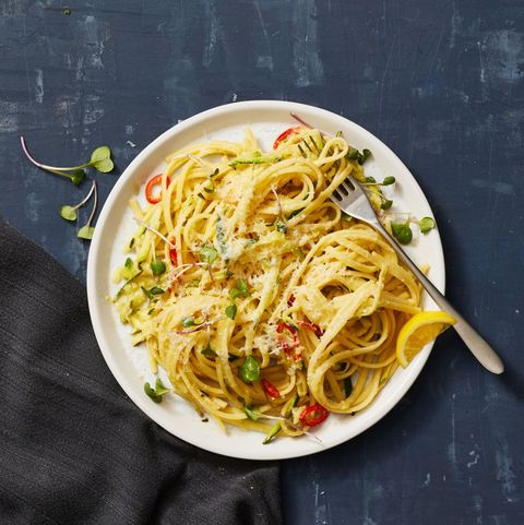 zucchini linguine with lemon on a white plate