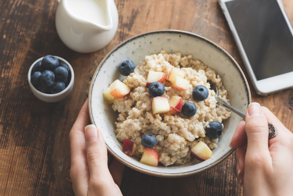 Eating healthy breakfast. Oatmeal porridge in bowl