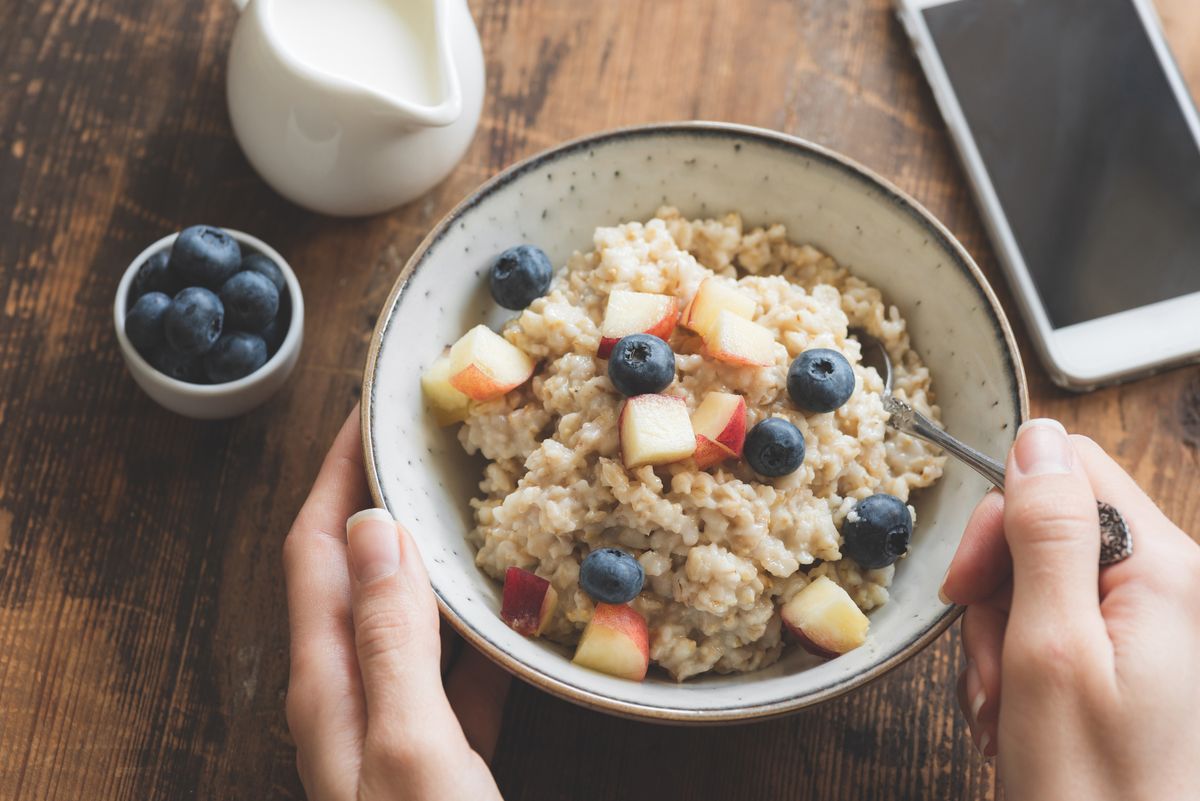 eating healthy breakfast oatmeal porridge in bowl