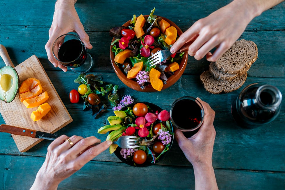 eating mixed salads and drinking red wine