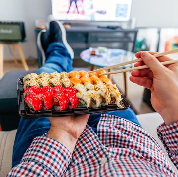 eating sushi delivery at home while laying on the couch, personal perspective view