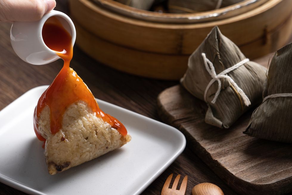 eating zongzi rice dumpling for dragon boat festival celebration
