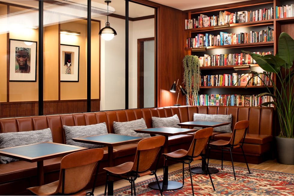 a room with a couch and chairs