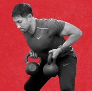 man doing bent over row with a pair of kettlebells