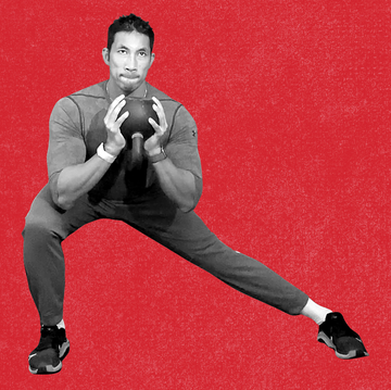 man doing lateral lunge with kettlebell, sitting in the bottom position