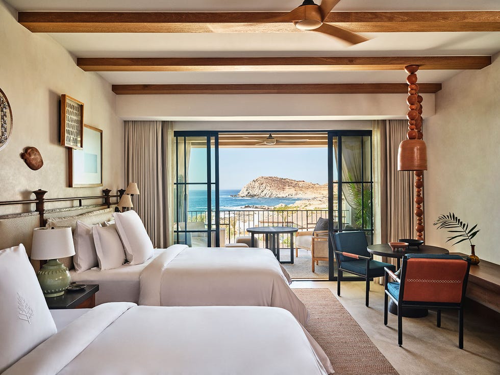 Cozy hotel room with two beds and a seaside view