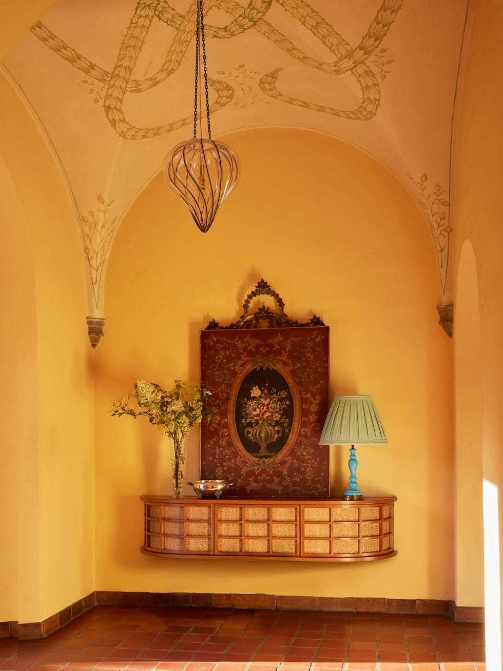 Entryway with vintage decor and lighting.