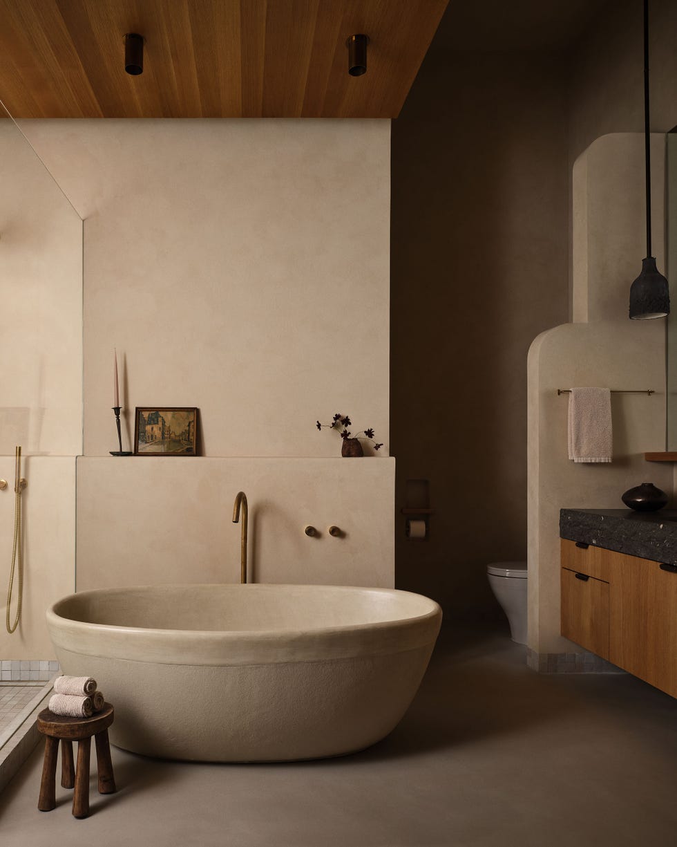 Modern bathroom featuring a freestanding tub and natural materials.