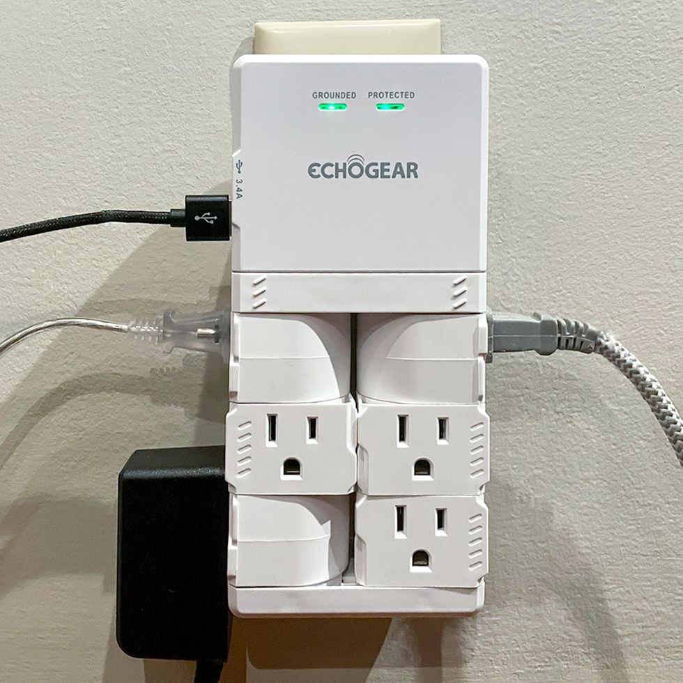 echogear surge protector outlet plugged into the wall with 4 plugs in use with it