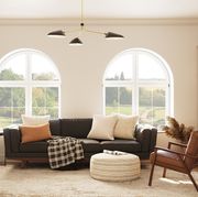 black couch in living room with arch windows