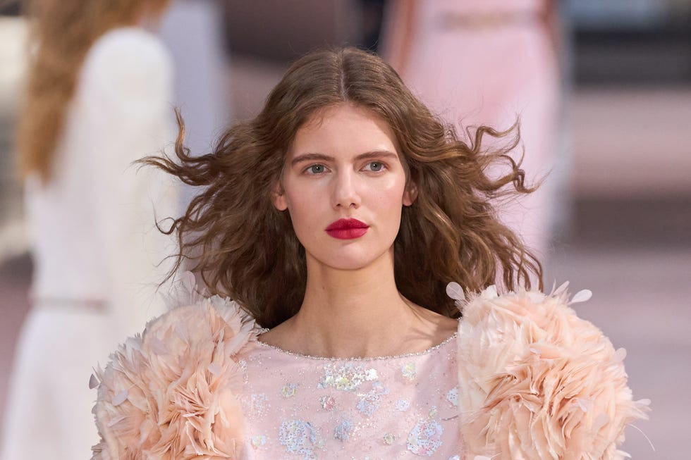Fashion model on a runway showcasing a designer outfit