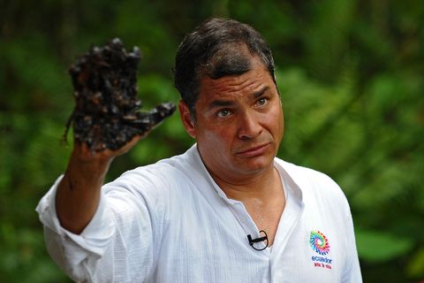 ecuadorean president rafael correa shows his oil covered hand at aguarico 4 oil well in aguarico, ecuador on september 17, 2013 aguarico 4 was operated by us oil company texaco between 1962 and 1990 correa called tuesday for a global boycott of chevron, as part of a campaign to highlight amazon environmental damage ecuador attributed to the us oil giant chevron has never worked directly in ecuador but inherited a pollution lawsuit when it acquired texaco in 2001, and has yet to pay an associated fine  afp photo  rodrigo buendia        photo credit should read rodrigo buendiaafp via getty images