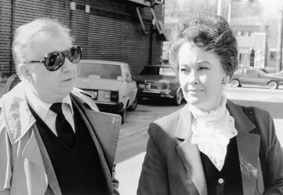 man and woman standing outside a courthouse