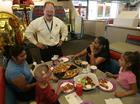 ed porter, area director for chuck e cheese, chats with a family having a birthday party this sto