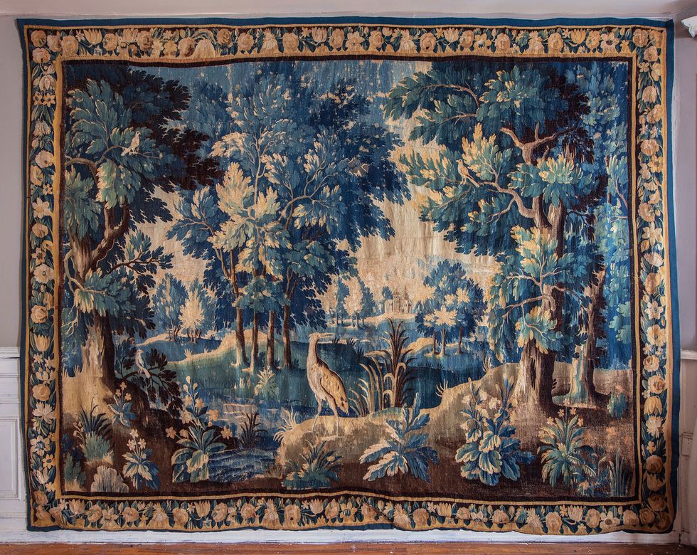 antique tapestry featuring a landscape