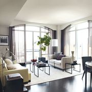 in the living area of hilarys manhattan apartment designed by mark zeff the sofas and tables and rug are by calvin klein home