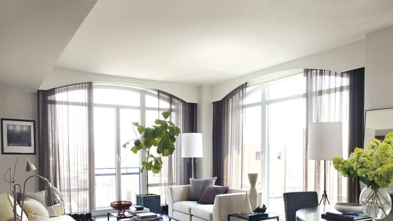 in the living area of hilarys manhattan apartment designed by mark zeff the sofas and tables and rug are by calvin klein home