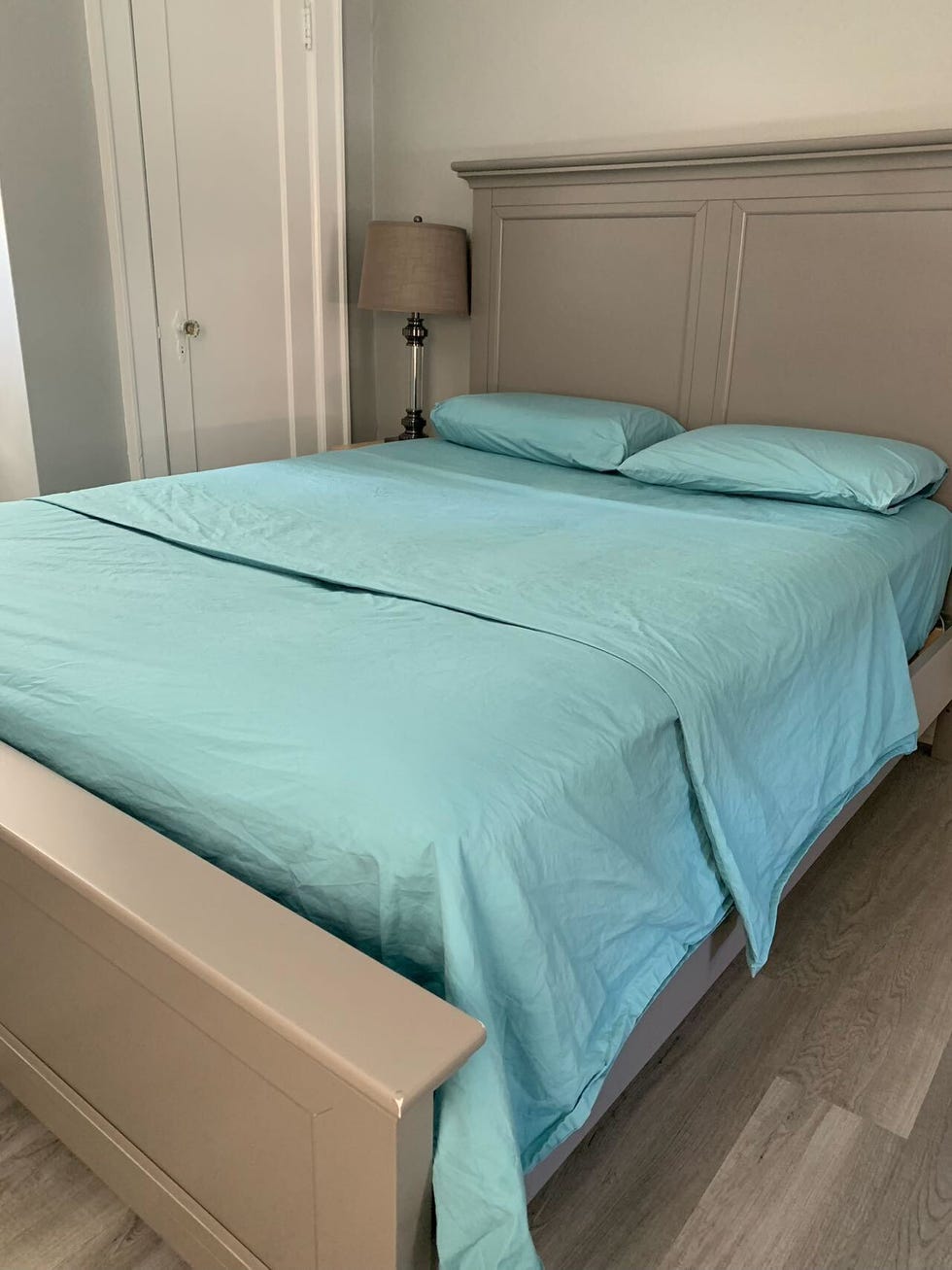 blue brooklinen classic percale sheets made on a bed, good housekeeping's brooklinen sheets review