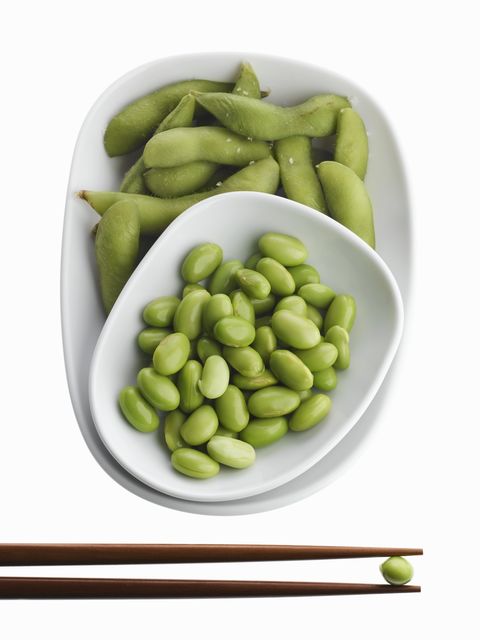 Edamame in bowl with chopsticks, overhead view