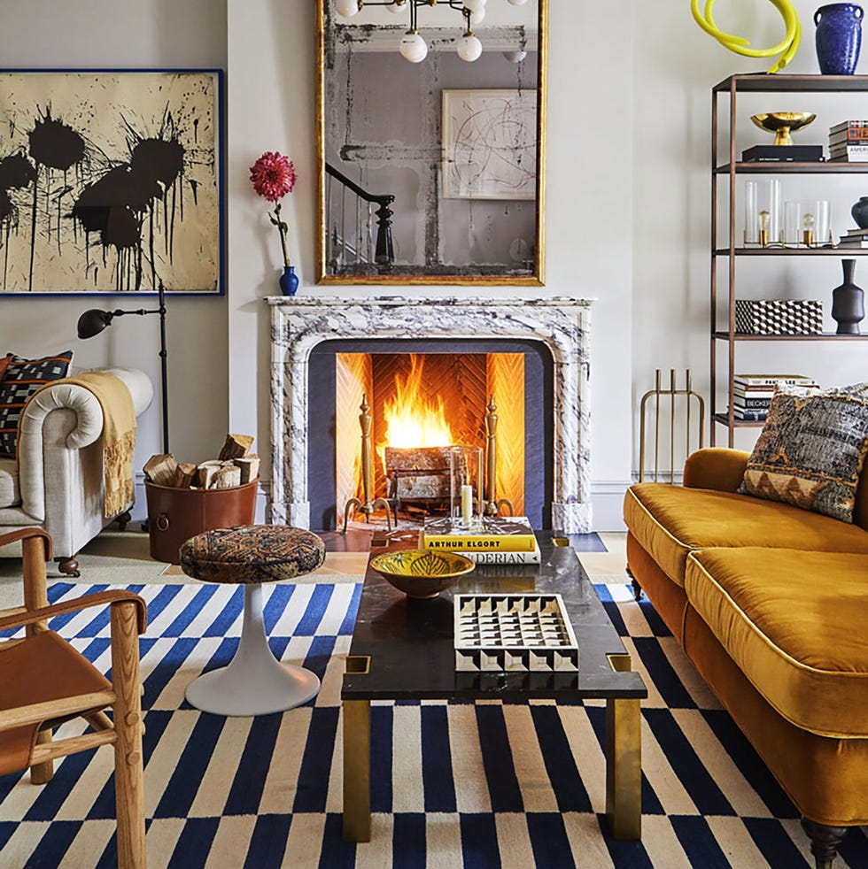 living room with striped rug, orange sofa and fireplace