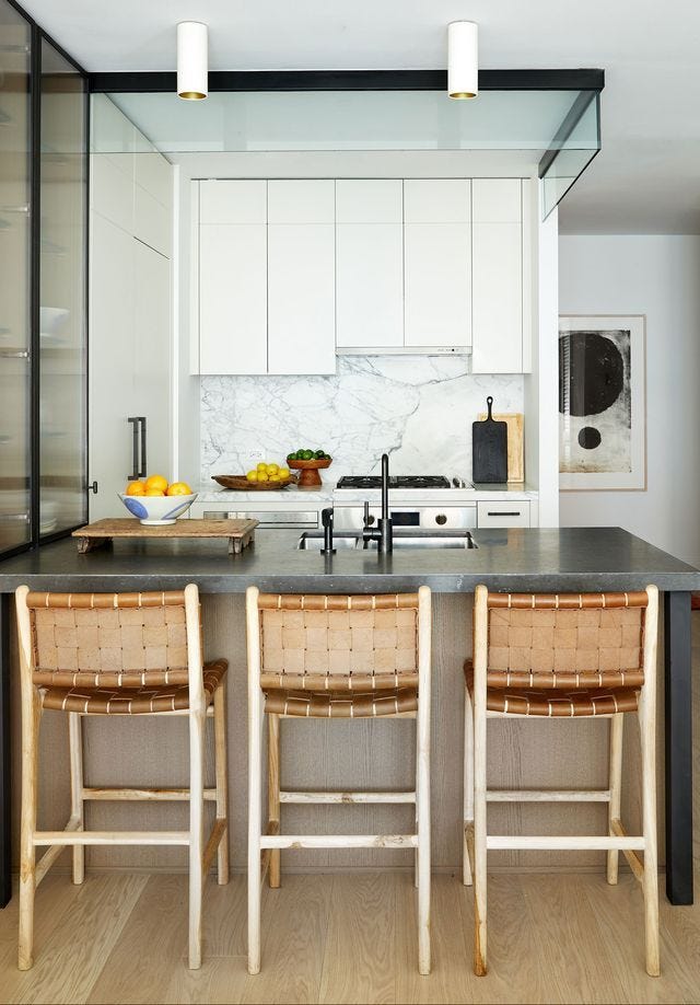 a kitchen with a marble counter top a kitchen with a marble counter top