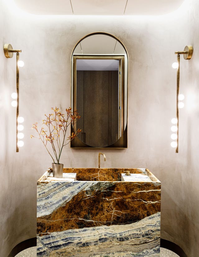 bathroom with side lights and marbleized vanity