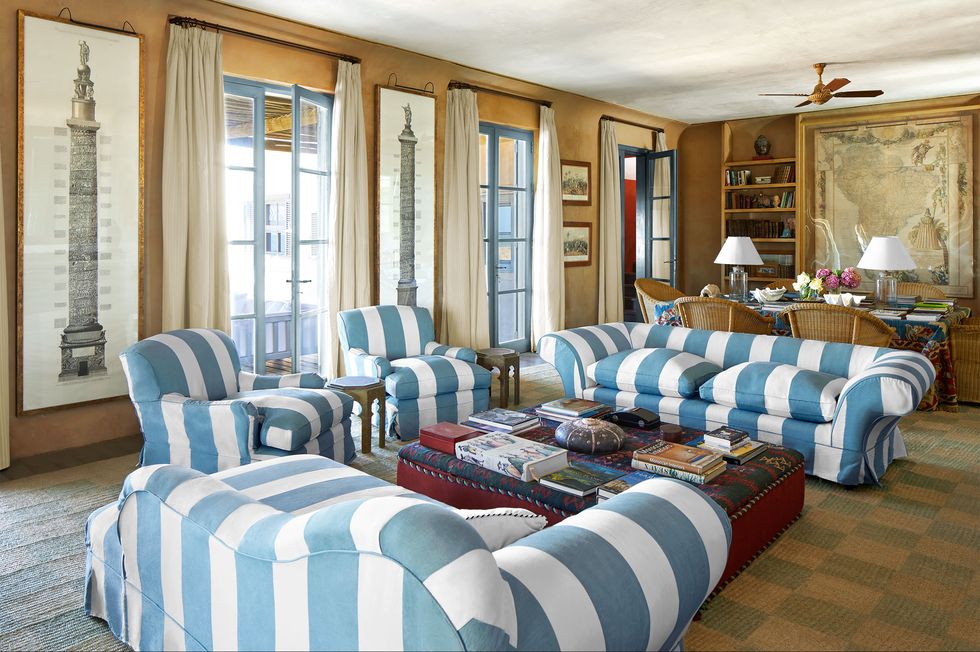 living room with blue and white striped chairs and sofas