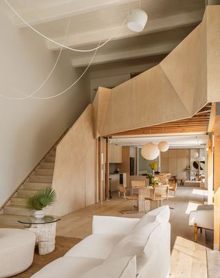 dining room with large sweeping staircase to loft area