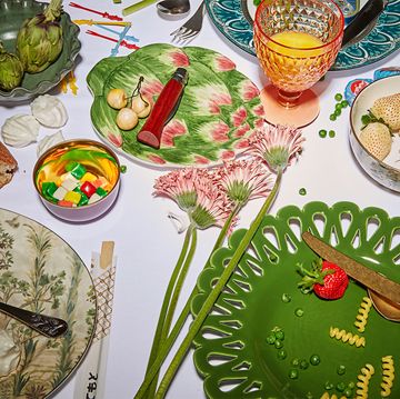 a table with plates and food in various colors and shapes