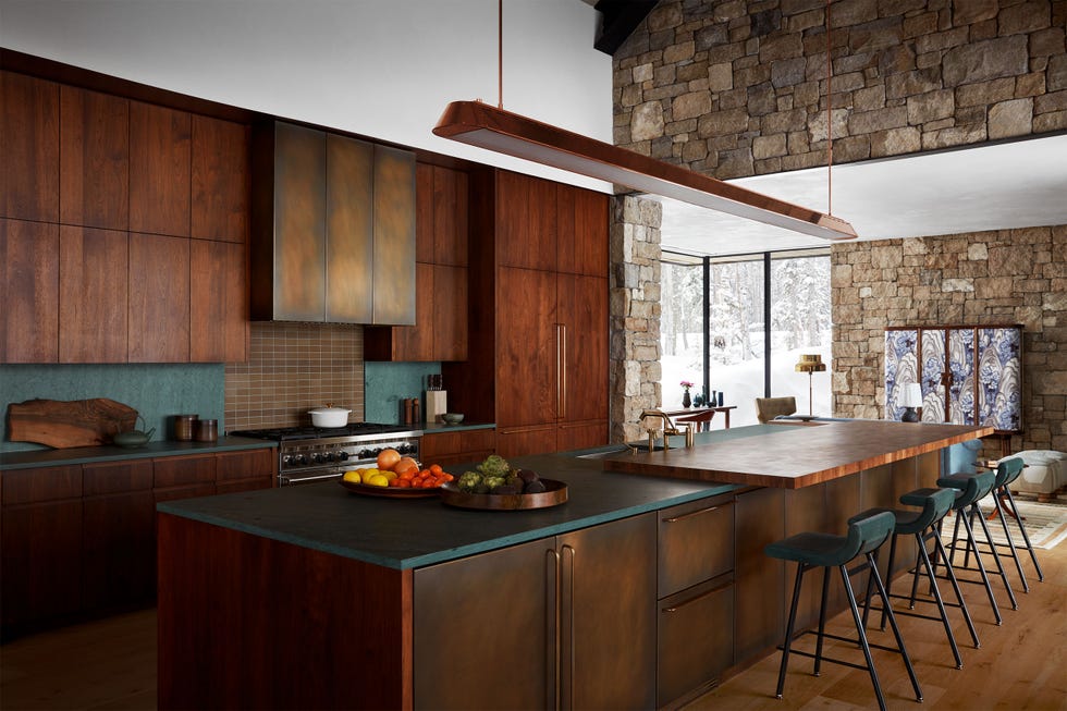 sleek wood kitchen with long counter and stools along the front