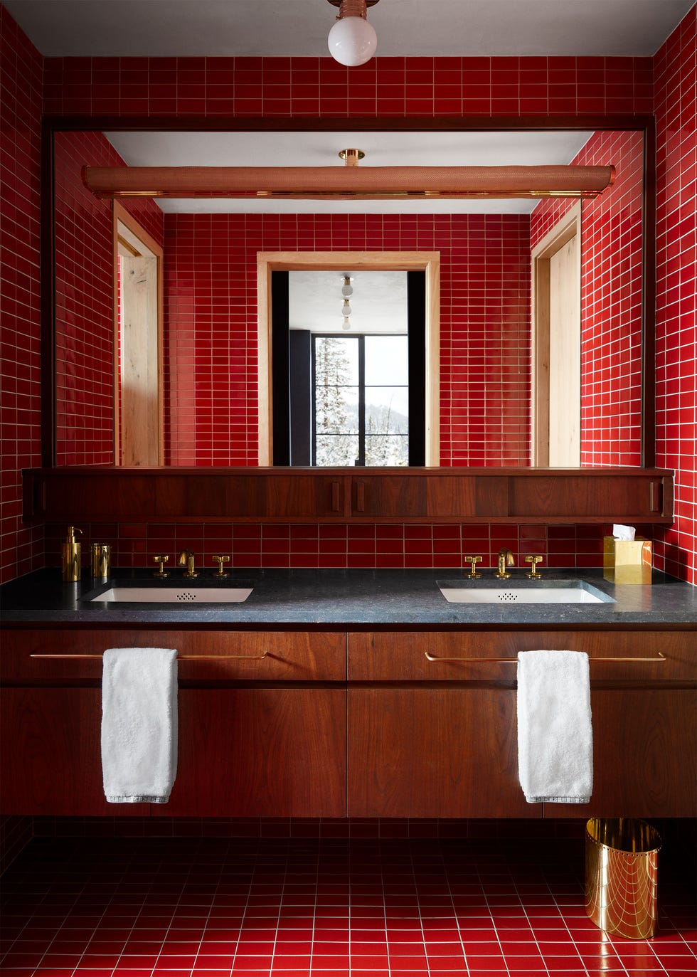 red tiled bathroom with reddish hued wood cabinetry