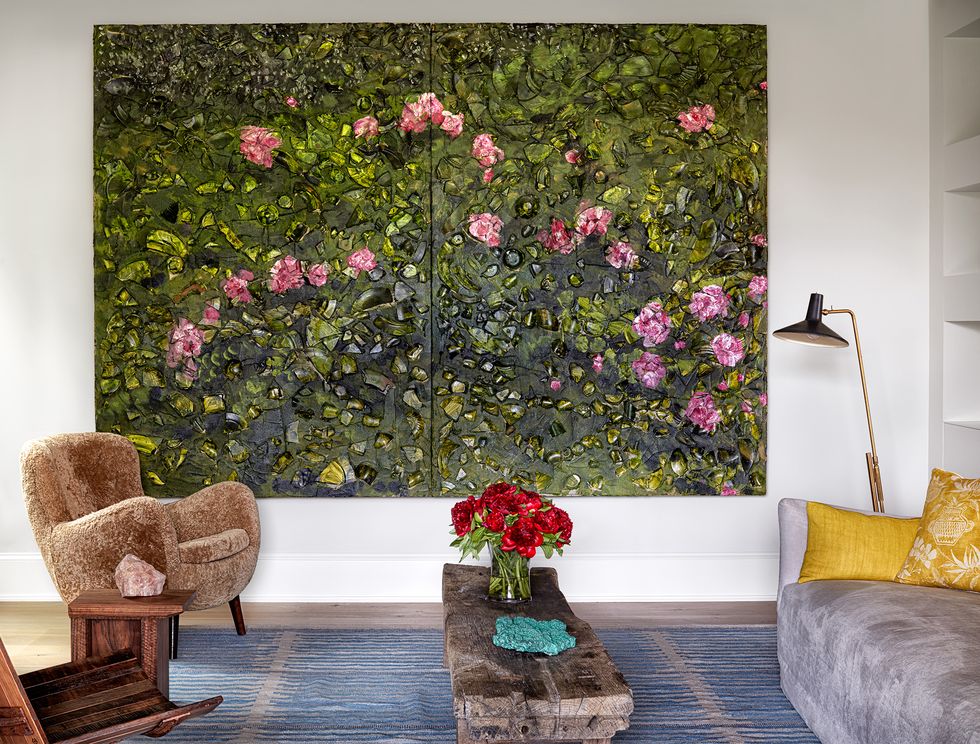 large floral painting between chair, bench and sofa
