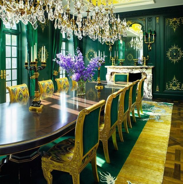 dining wroom in green and golds with long mahogany oval table with gilt chairs with green backs