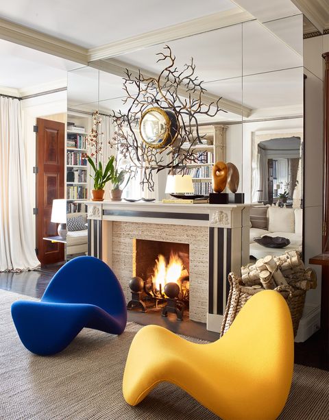 living room with fireplace and potato chip chairs in blue and yellow