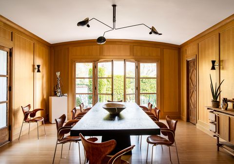 dining room with oak paneling and wooden table at center