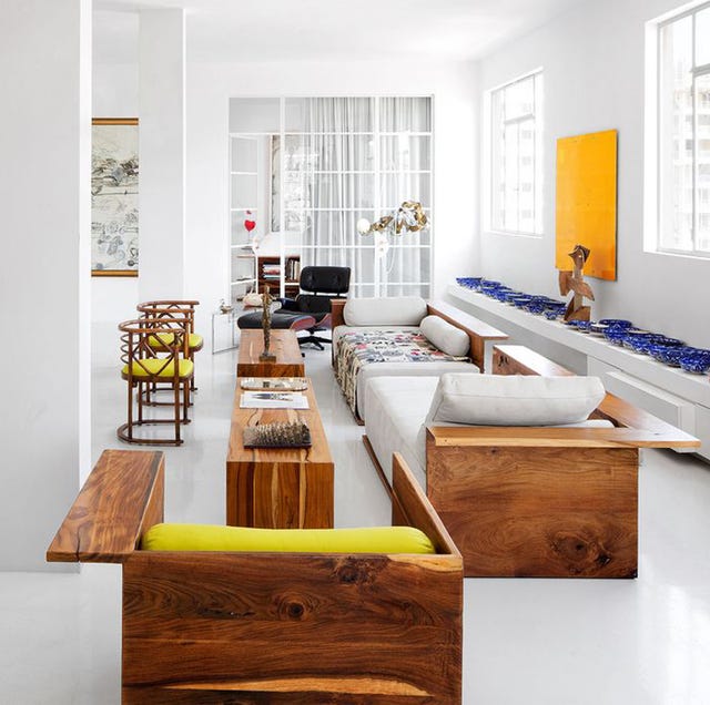 white living room with lovely stained wood pieces and side console with blue objets