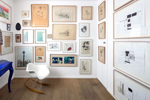 room with drawings and artworks on wall