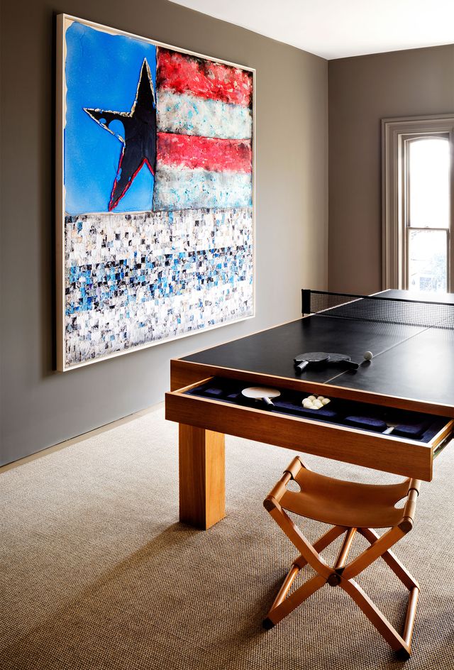 room with ping pong table and large impressionistic flag art on wall