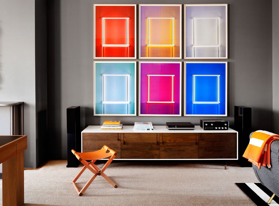living room with long console and large 6 paneled artwork in neon colors above it
