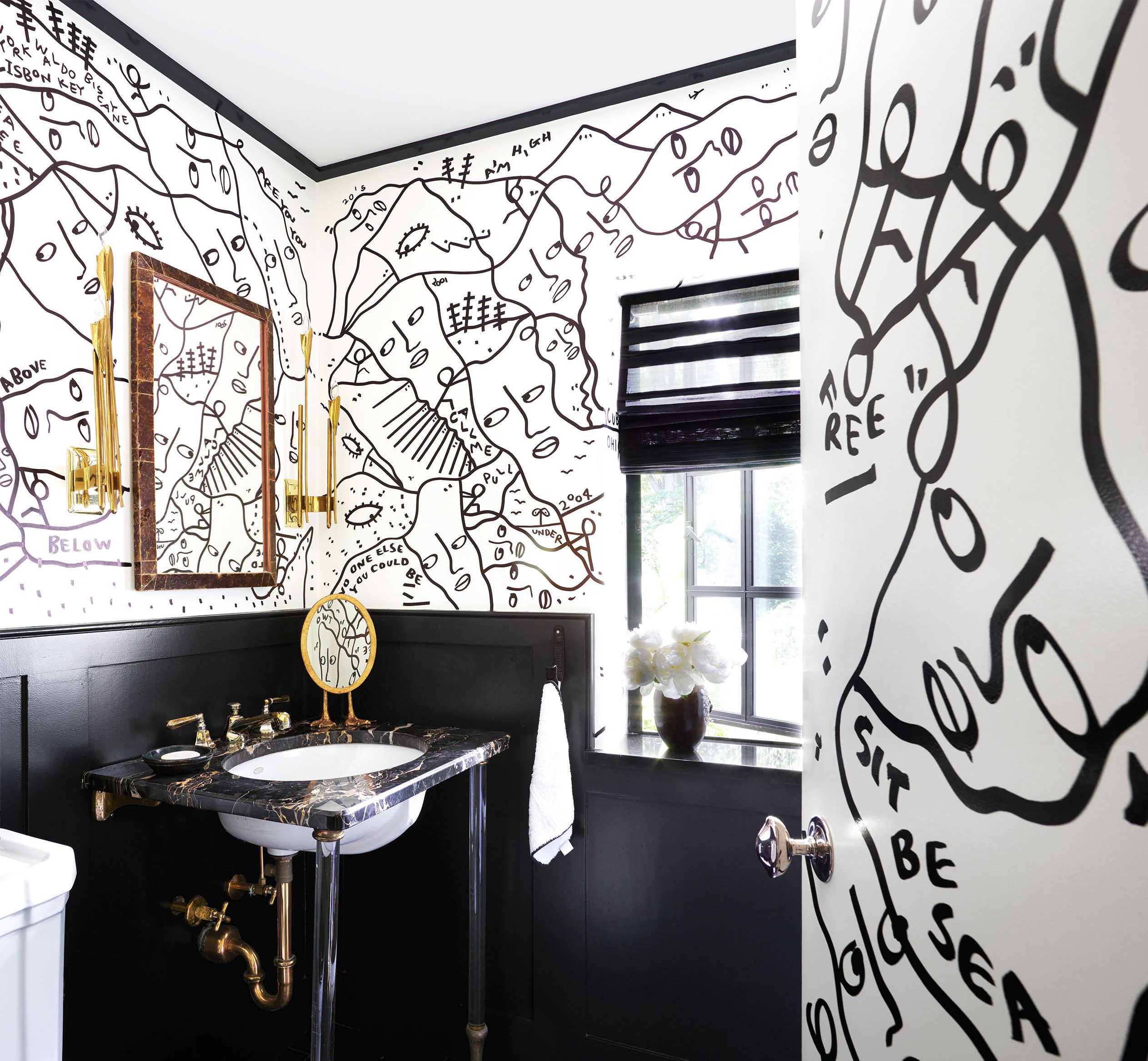 A renovated black and white bathroom with wallpaper black vanity  decorative tiles on the floor and subway tiles in the shower Stock Photo   Alamy