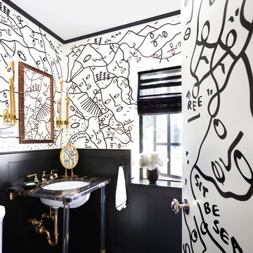 bathroom with black and white illustrated mural on walls