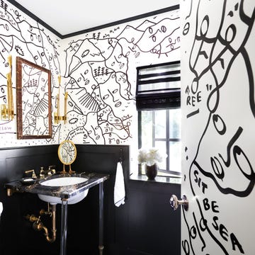 bathroom with black and white illustrated mural on walls