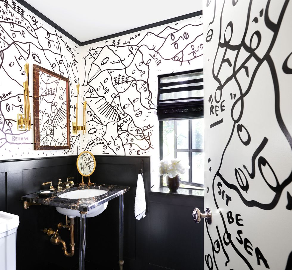 bathroom with black and white illustrated mural on walls