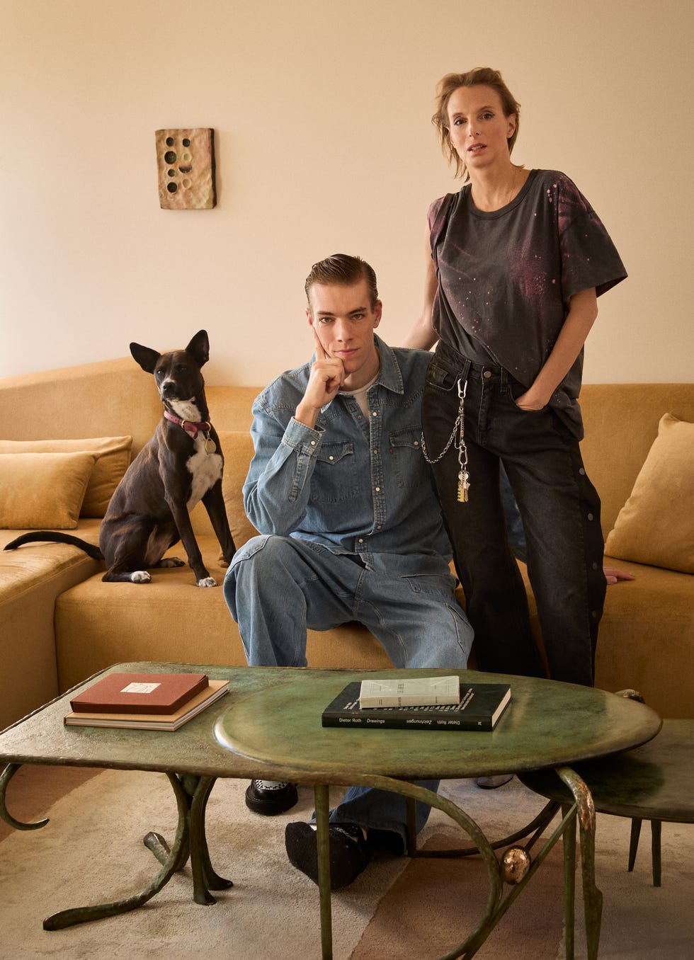 a couple poses with a dog in a cozy living room setting