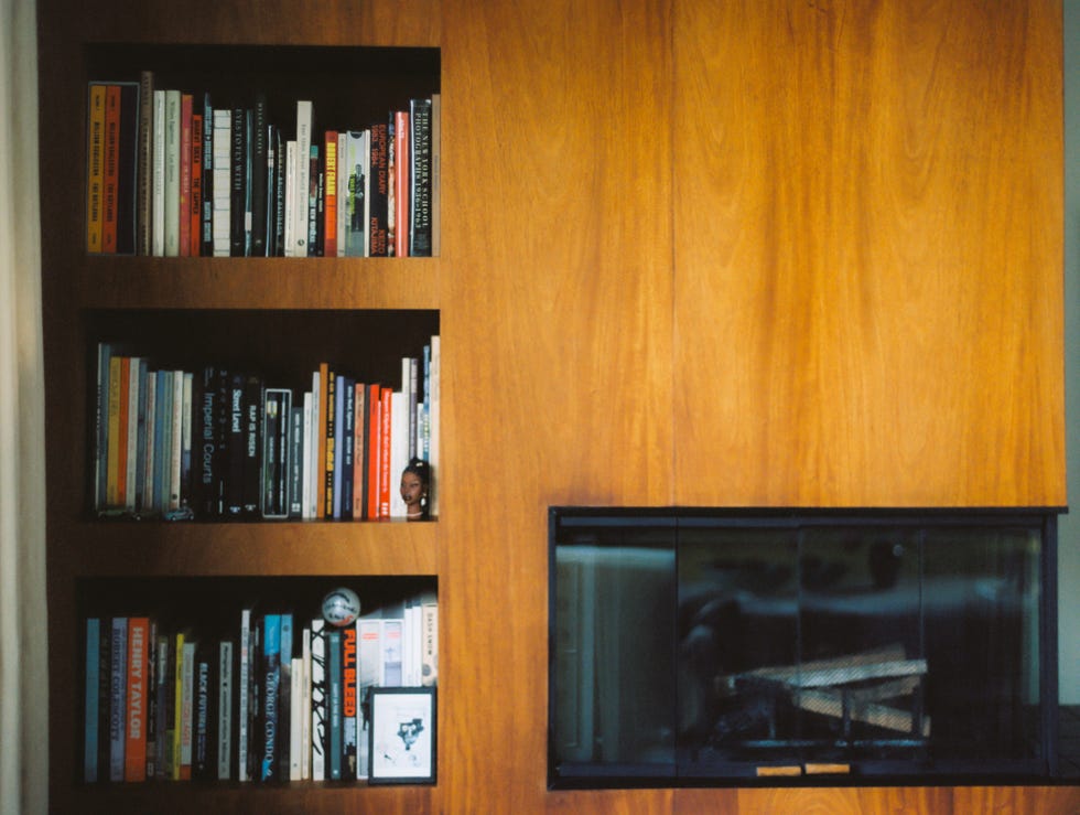 wooden bookshelf with books and a fireplace