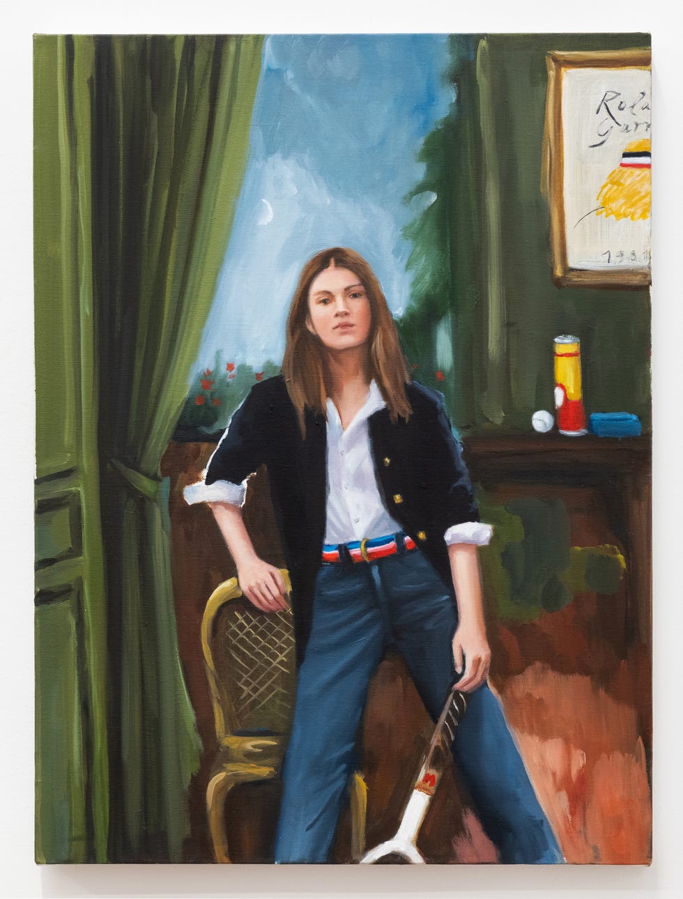 a figure wearing a shirt and jacket with a guitar resting at their feet against a backdrop of green curtains and a bulletin board